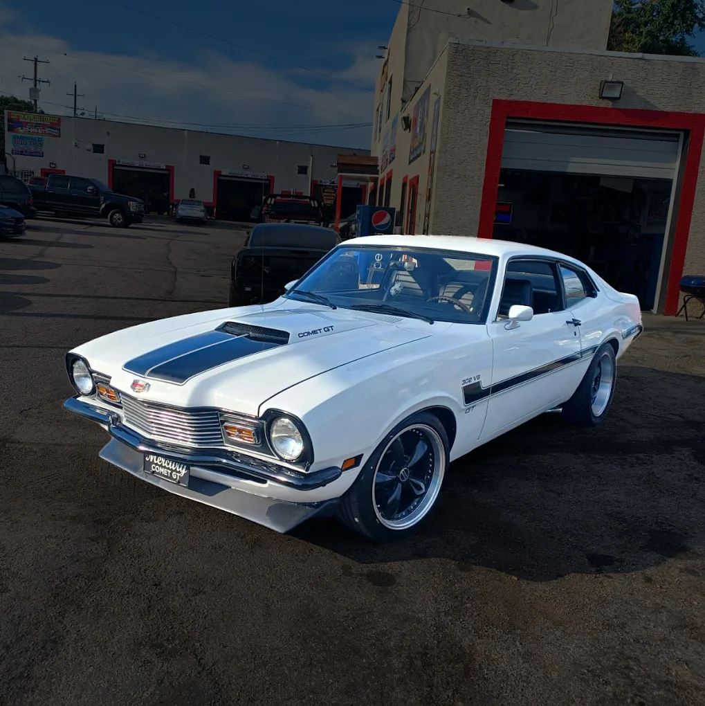 White classic coupe with a dark custom hood graphic