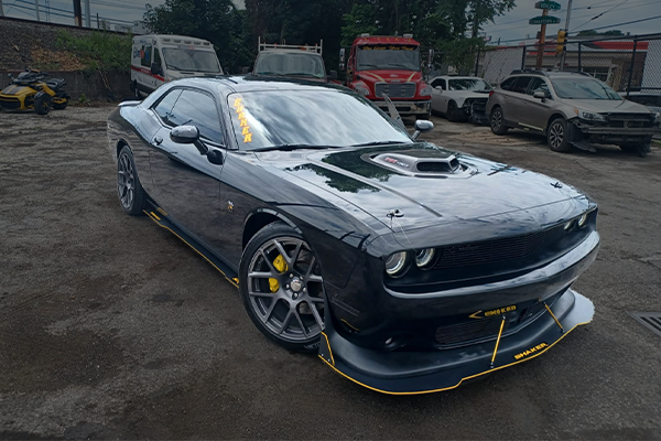 Black Dodge Challenger with custom yellow accent graphics