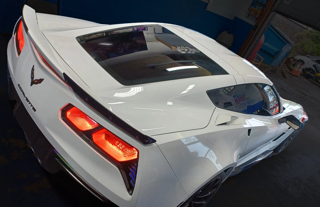 White Corvette with custom rear graphics inside the Andres Graphics Philly shop