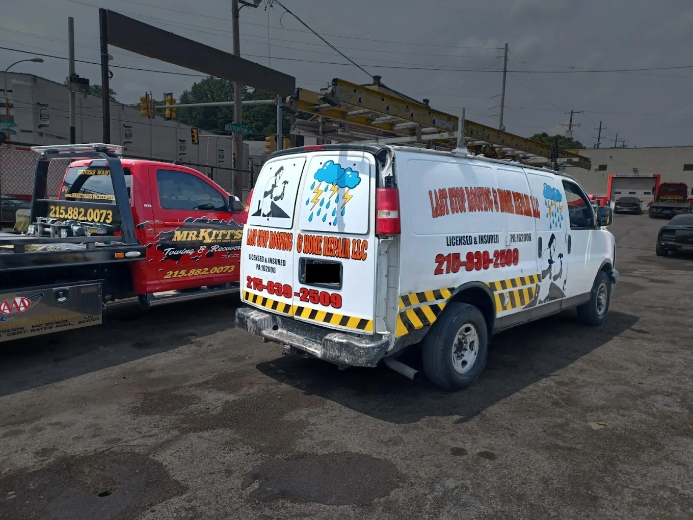 Two commercial vans with business graphics and lettering