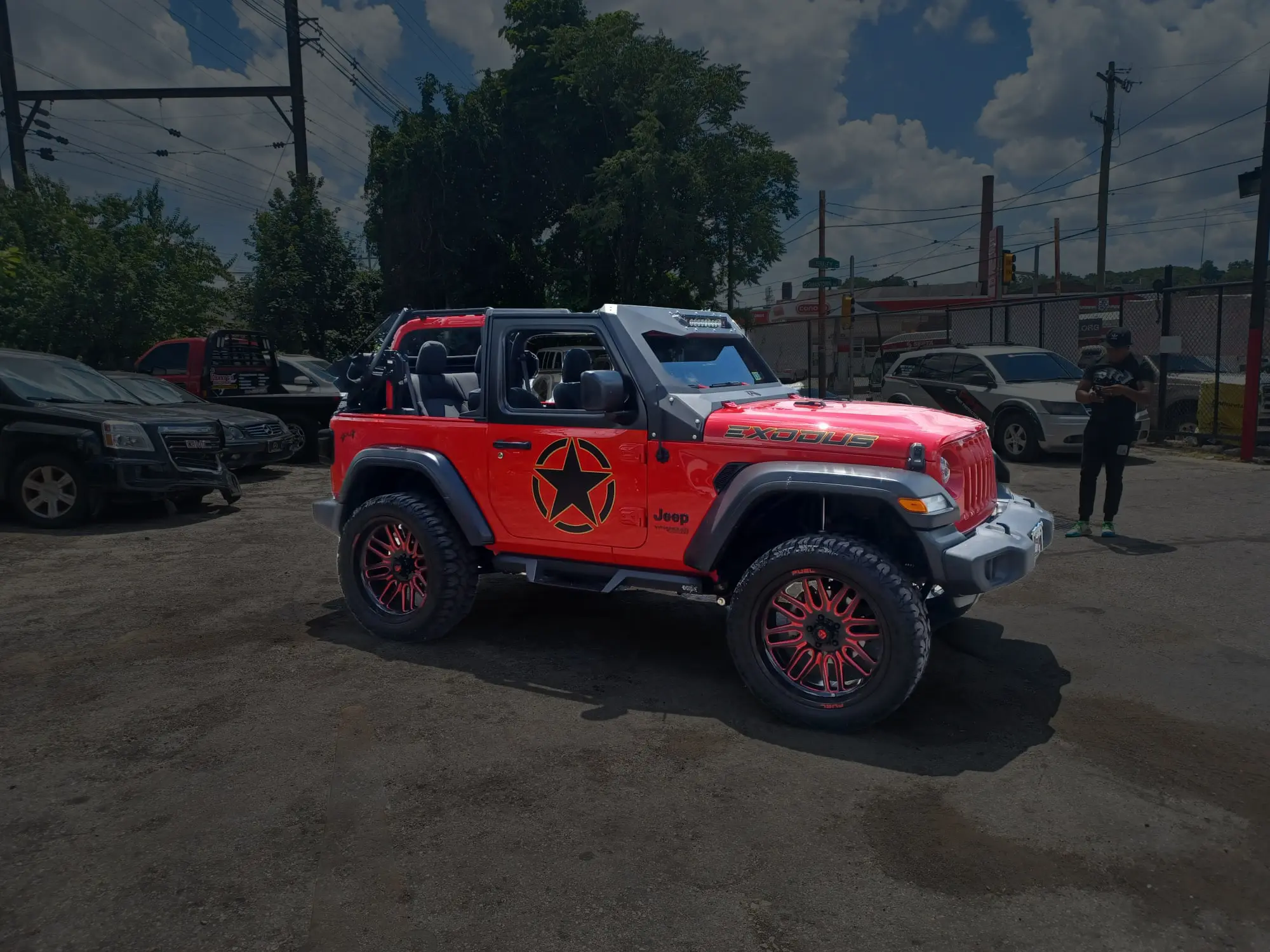 Red Jeep with custom black graphics