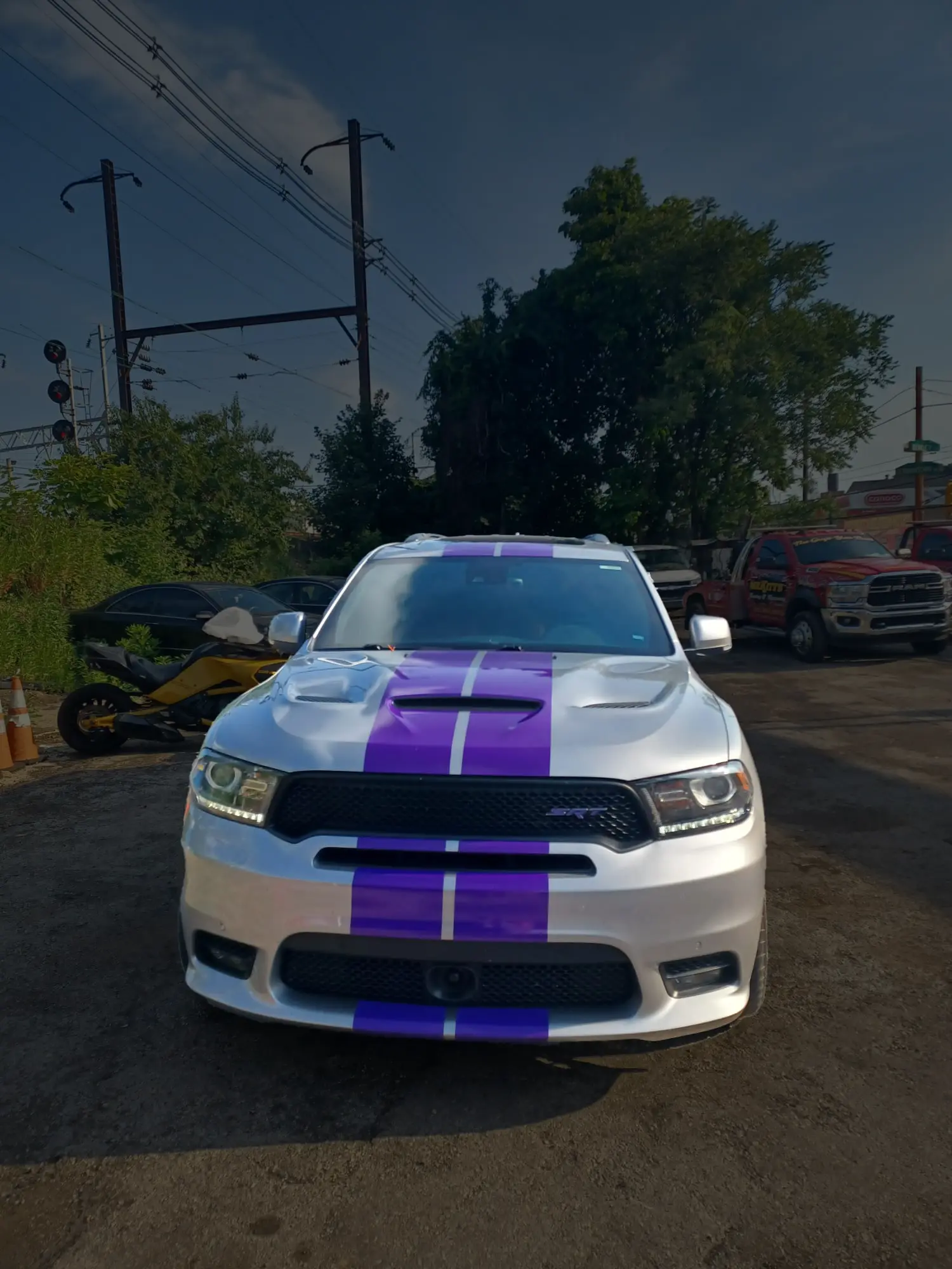 White Dodge with purple racing stripes